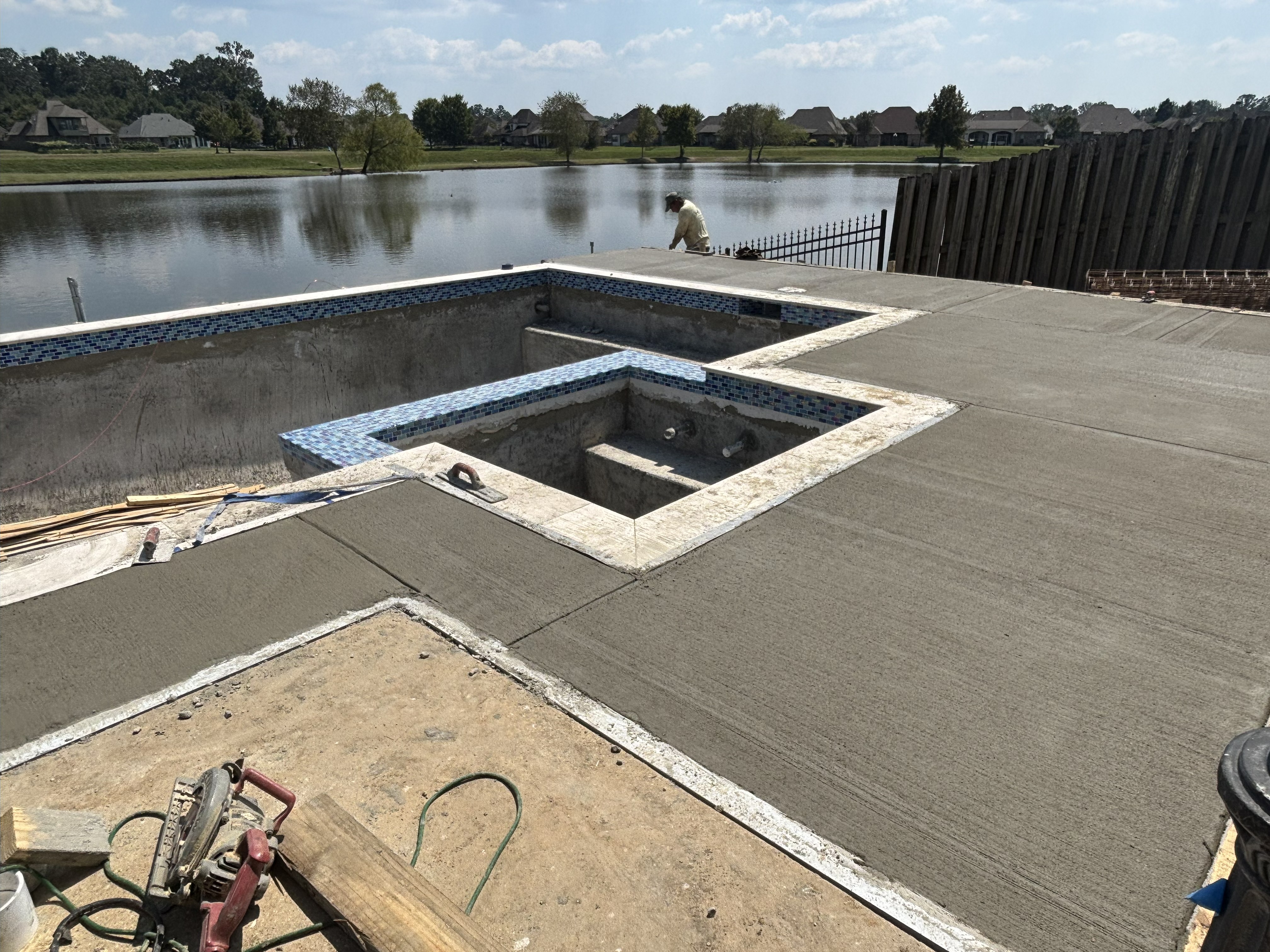 Crew applying new plaster finish to pool surface