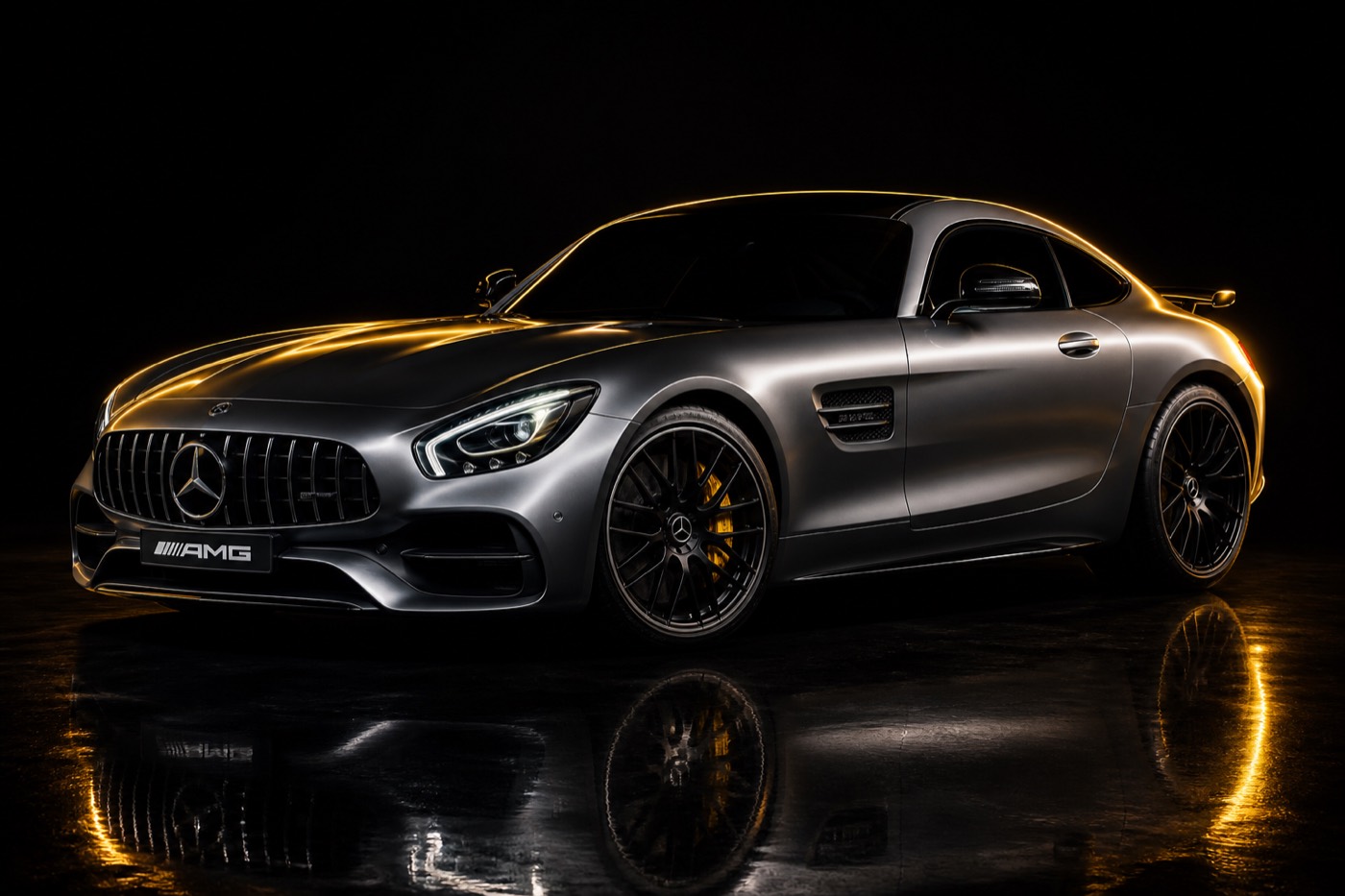 AMG GT in a black studio with gold rim light