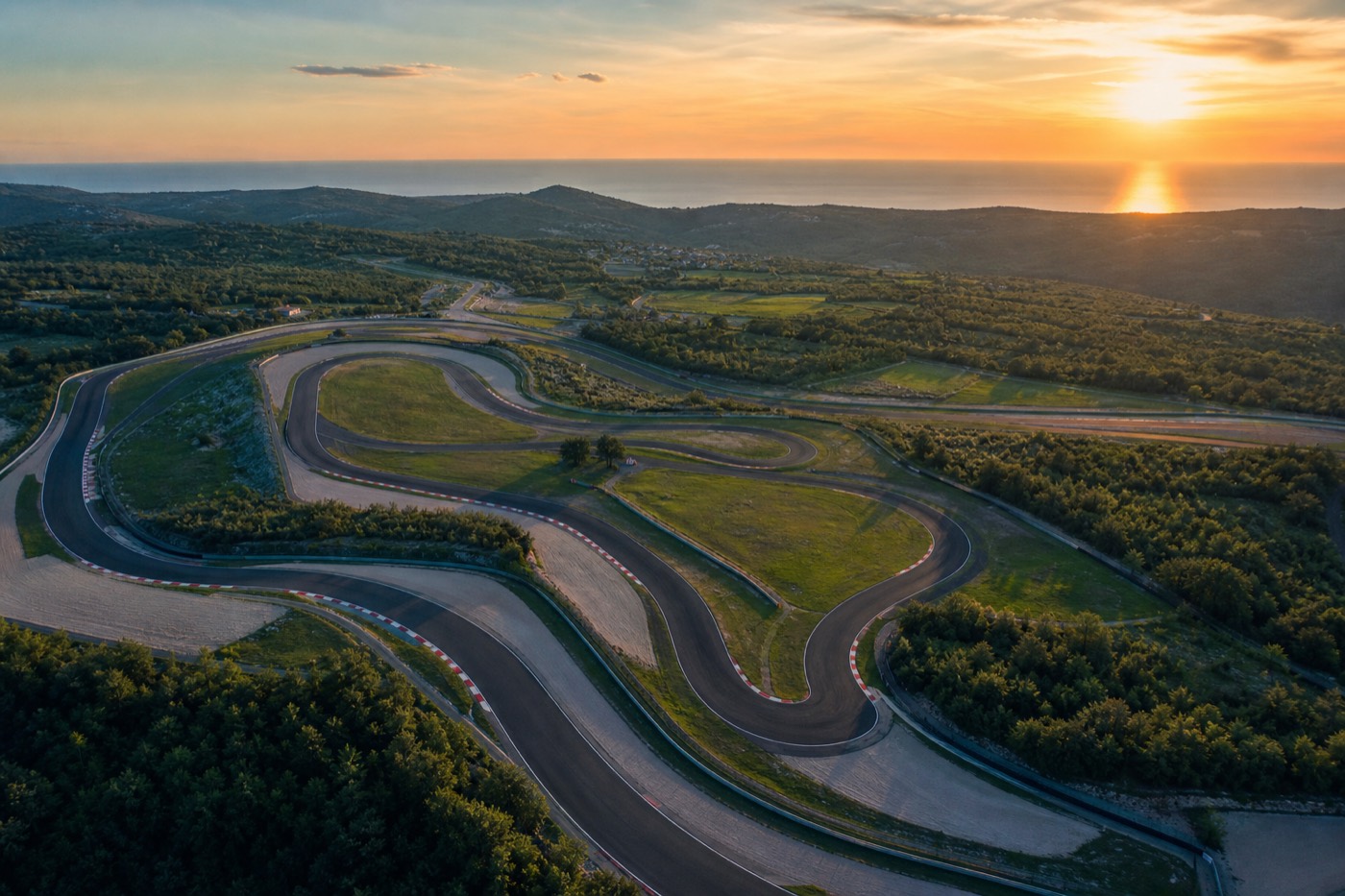 Empty circuit at Motodrom Poreč winding through the Istrian countryside at golden hour