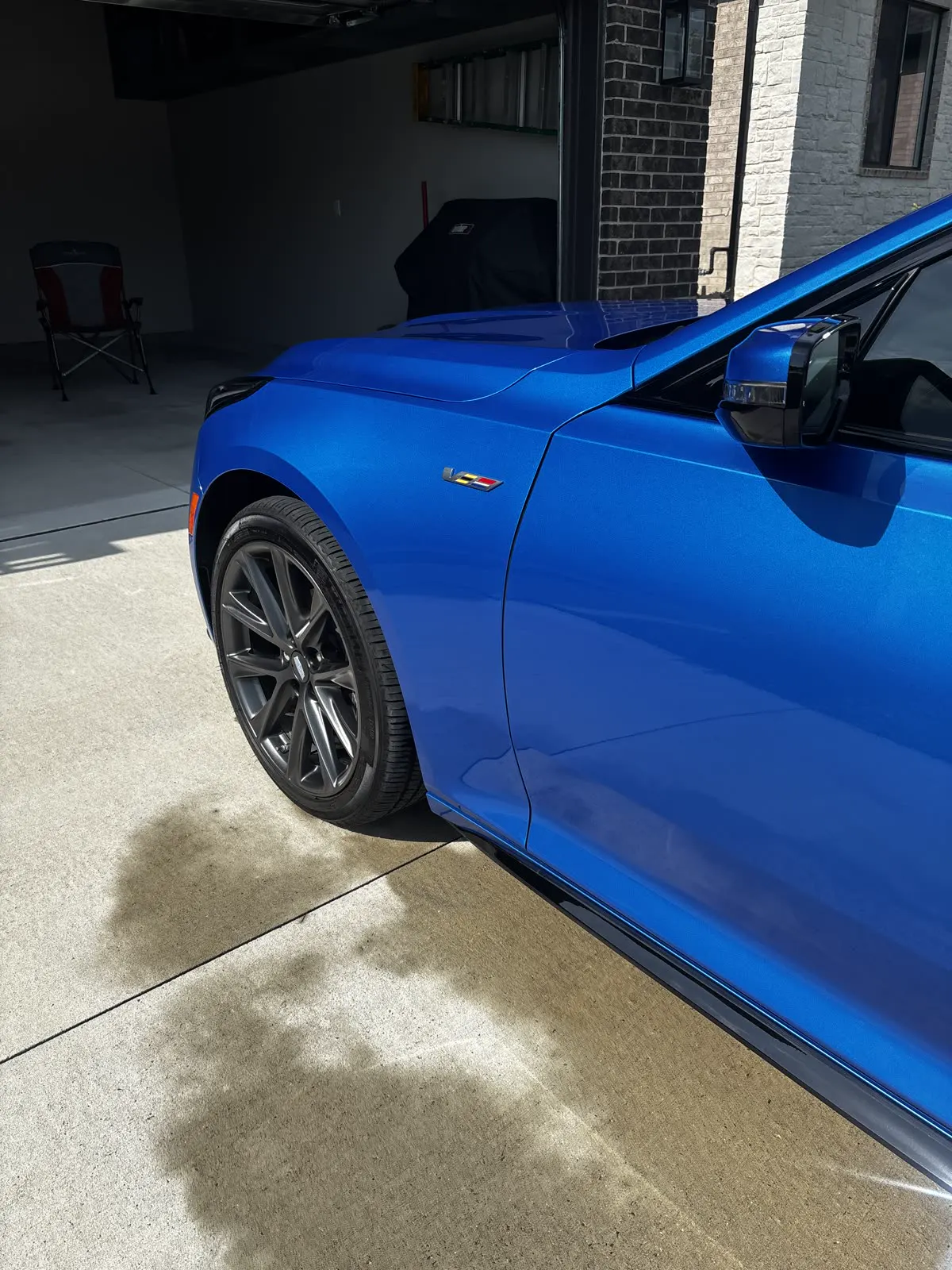 Blue coupe finished on a customer driveway
