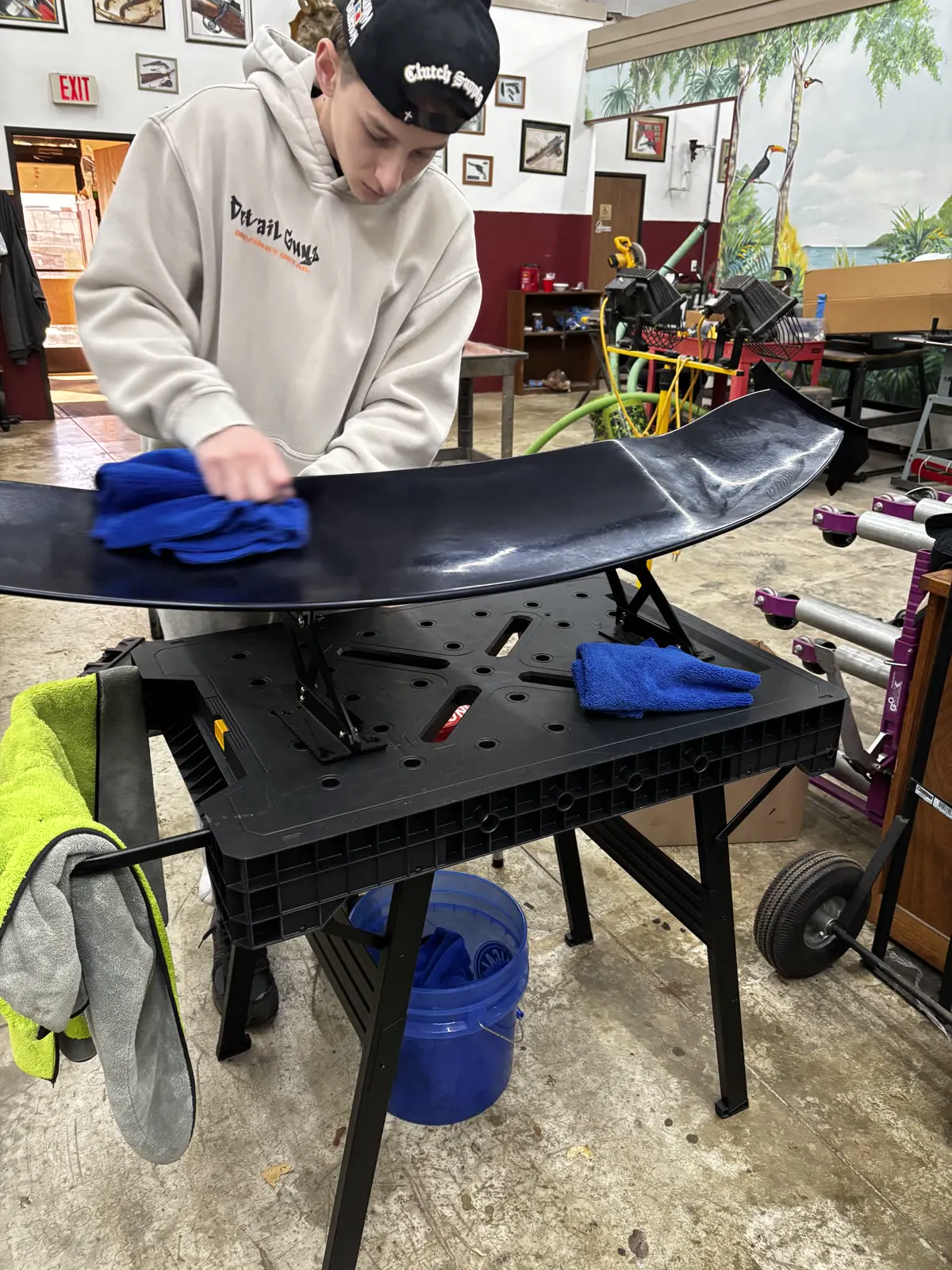 Technician polishing a spoiler on the bench