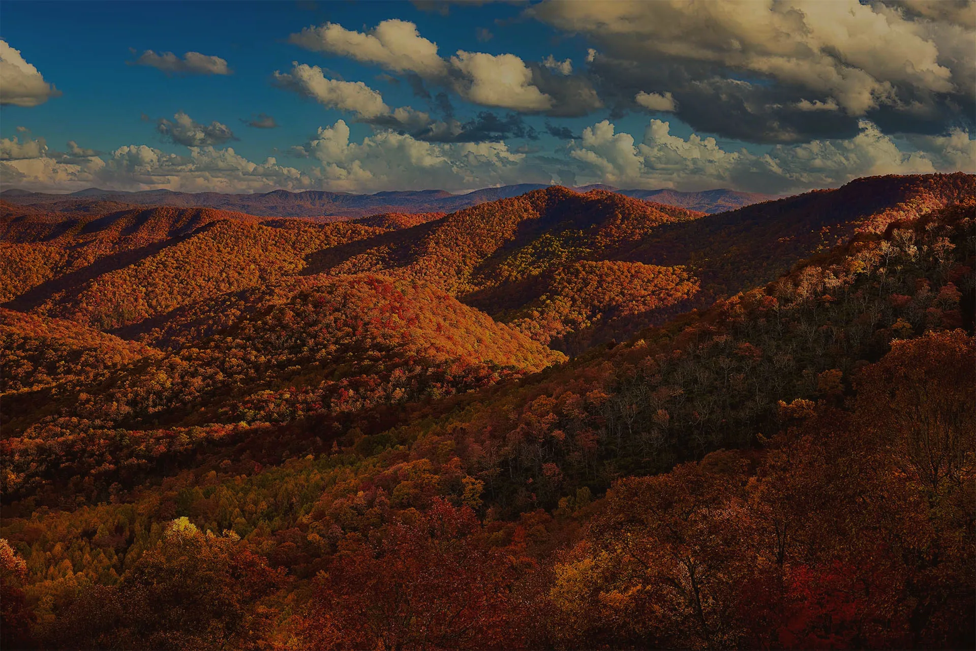 Aerial view of fall-colored ridgelines in the Great Smoky Mountains at sunset