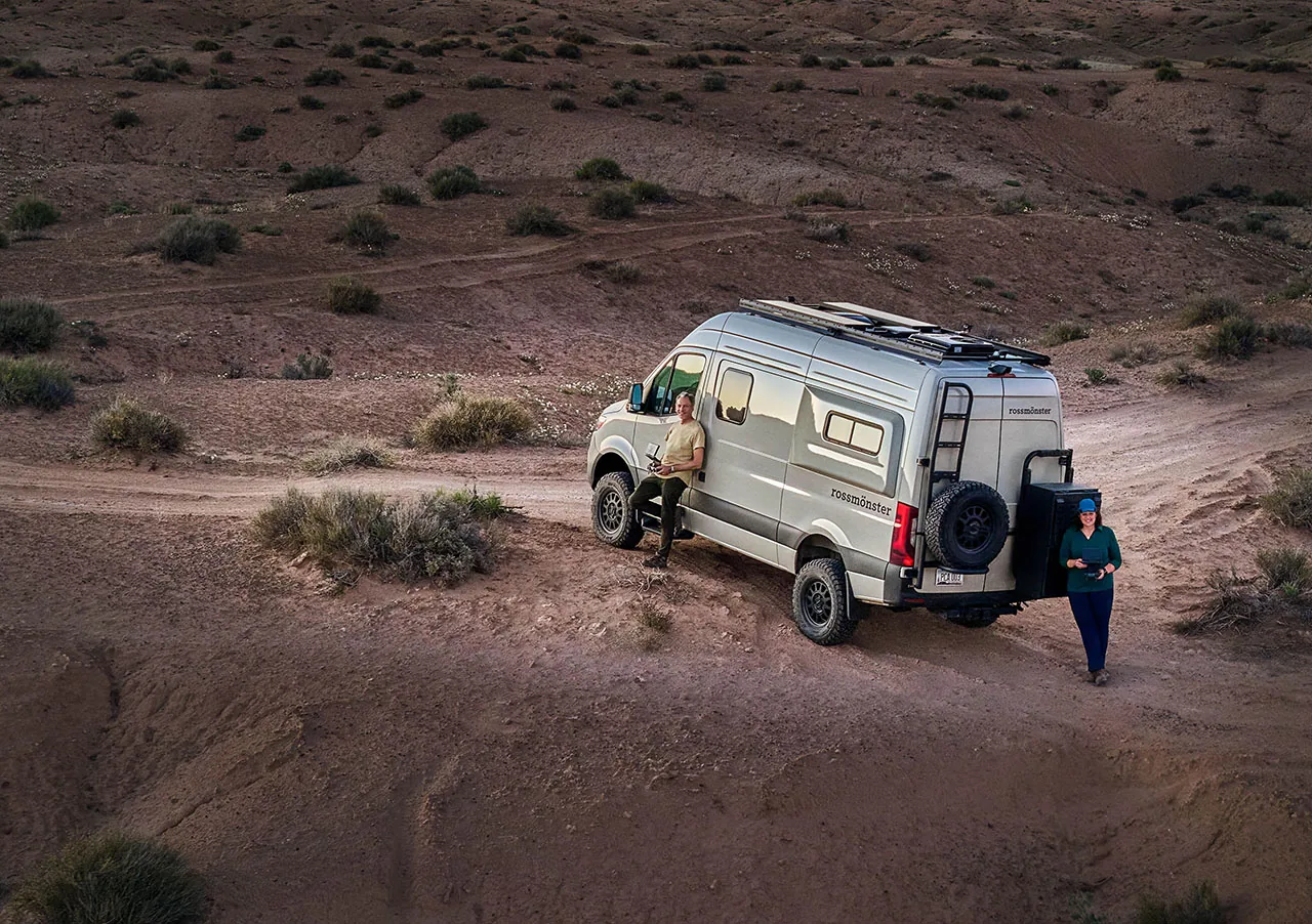 Greg Koorhan and Lynda Green standing beside their camper van near Factory Butte, Utah