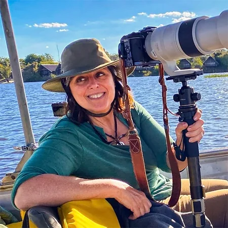 Lynda Green photographing wildlife from a boat with a telephoto lens
