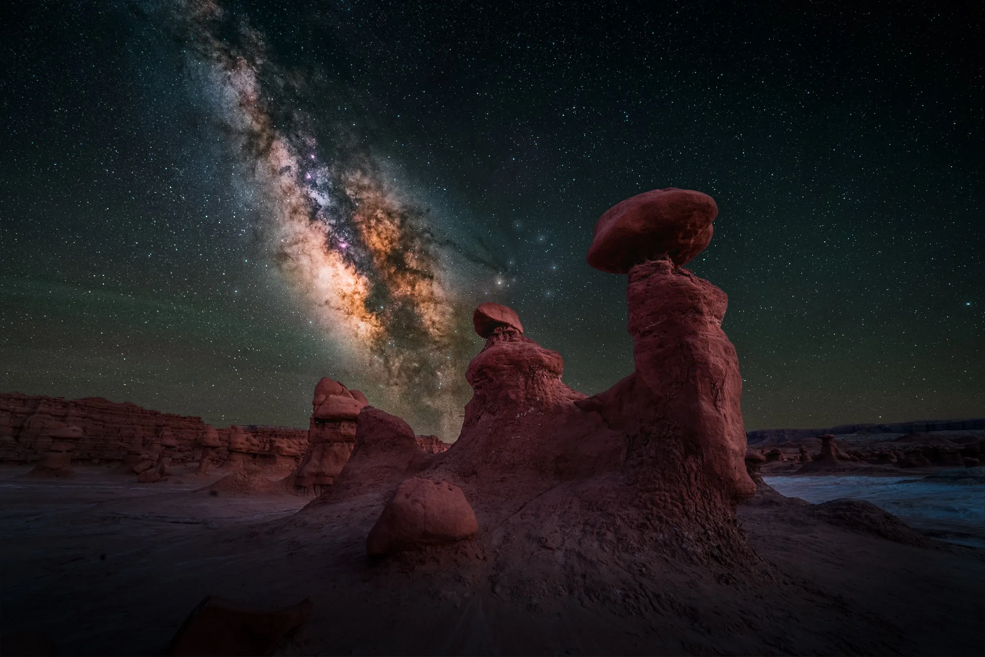 The Milky Way rising over hoodoo rock formations in Goblin Valley, Utah