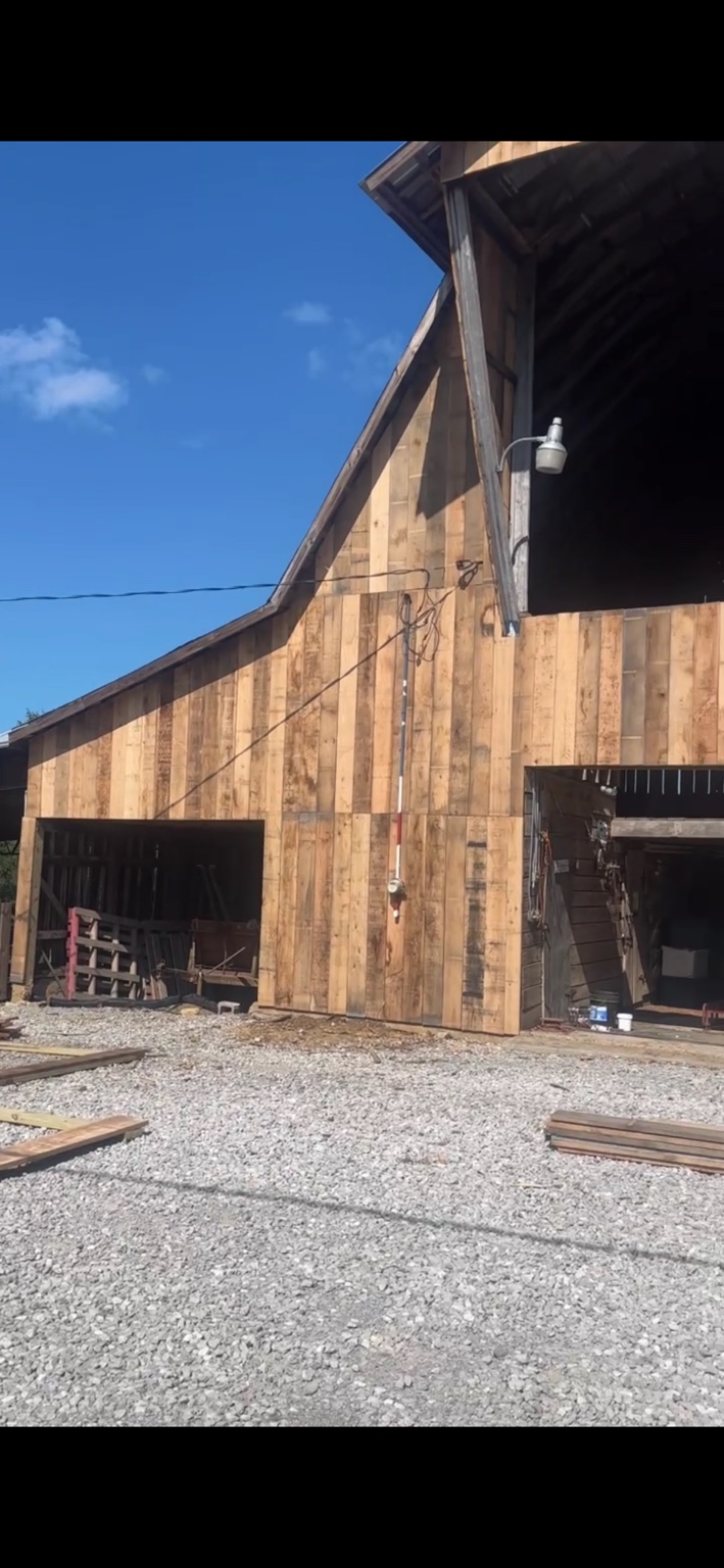 JT's Flag Barn — Weathered siding along the heritage barn wall during renovation