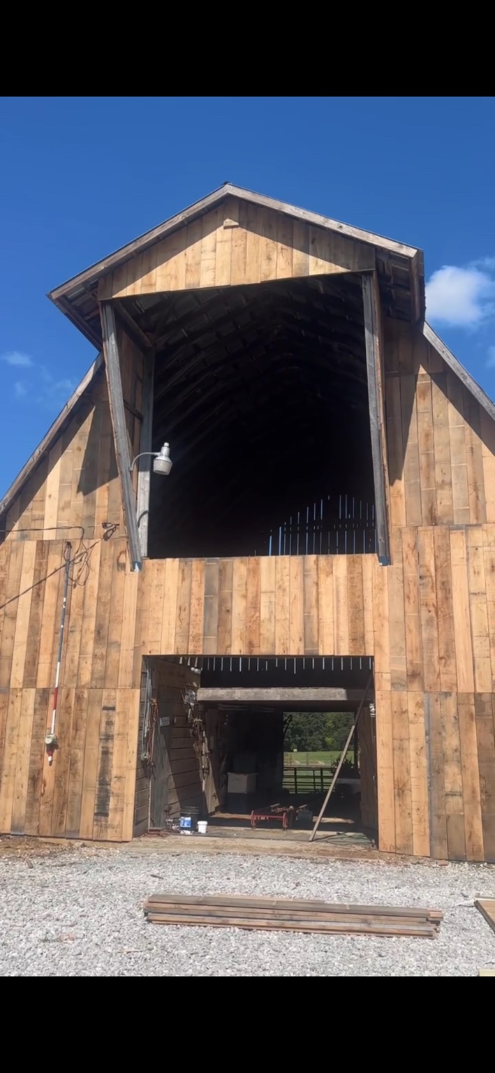 JT's Flag Barn — Renovation progress on the barn facade with new wood siding