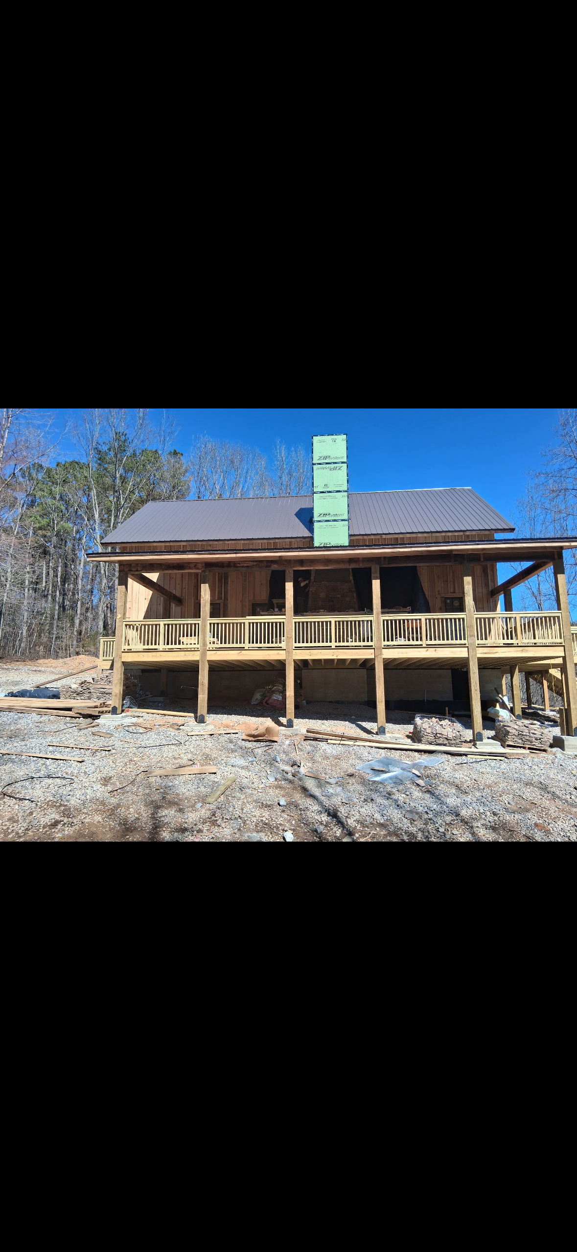 Rustic Custom Home — Roof and exterior finish work on the rural custom home