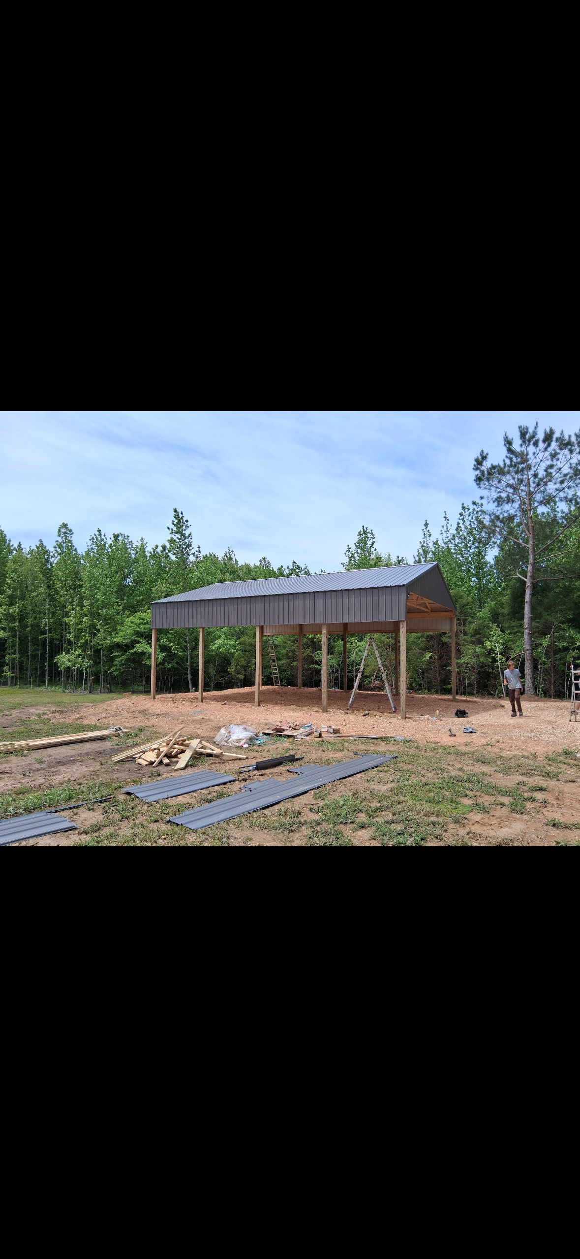 Open-Sided Pole Barn — Pole barn siding and trim work during construction