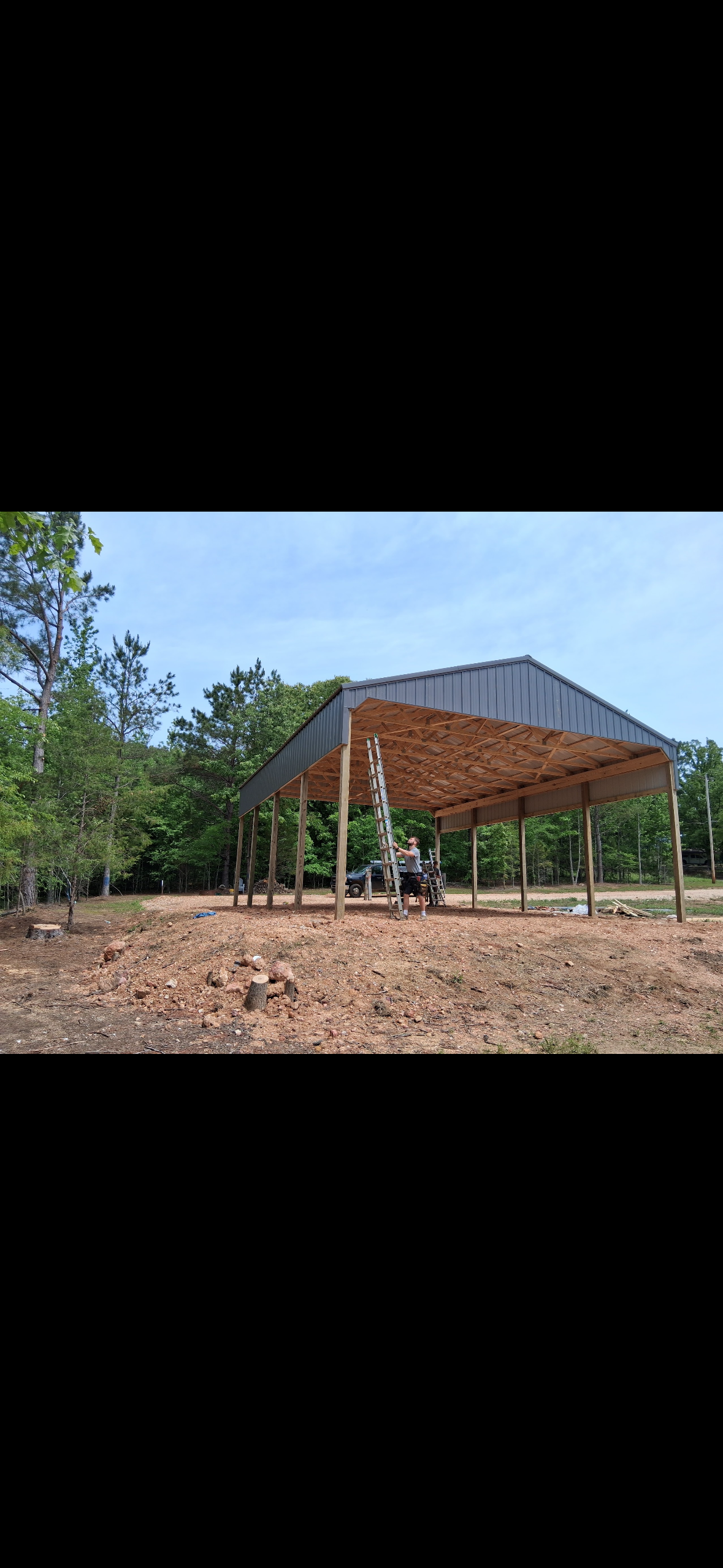Open-Sided Pole Barn — Open-sided framing with clear-span trusses for equipment access