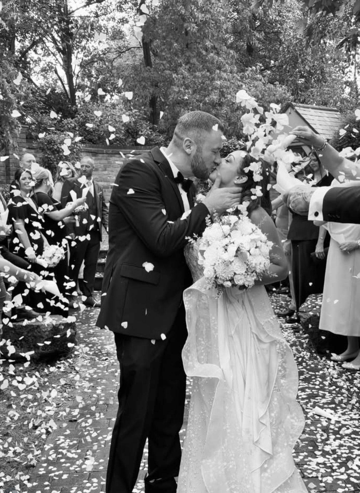 Couple kissing under a shower of confetti