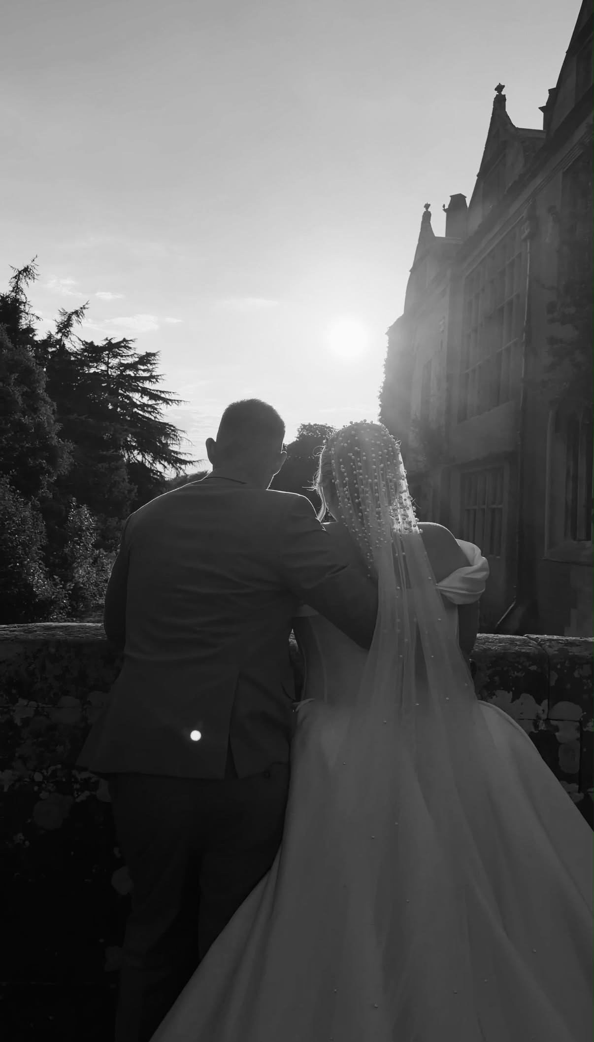 Couple walking together at sunset, seen from behind