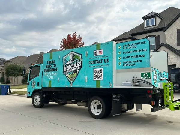 A Hercules Power Clean truck parked in a suburban neighborhood, ready for trash bin cleaning, dumpster cleaning, and pressure washing services.