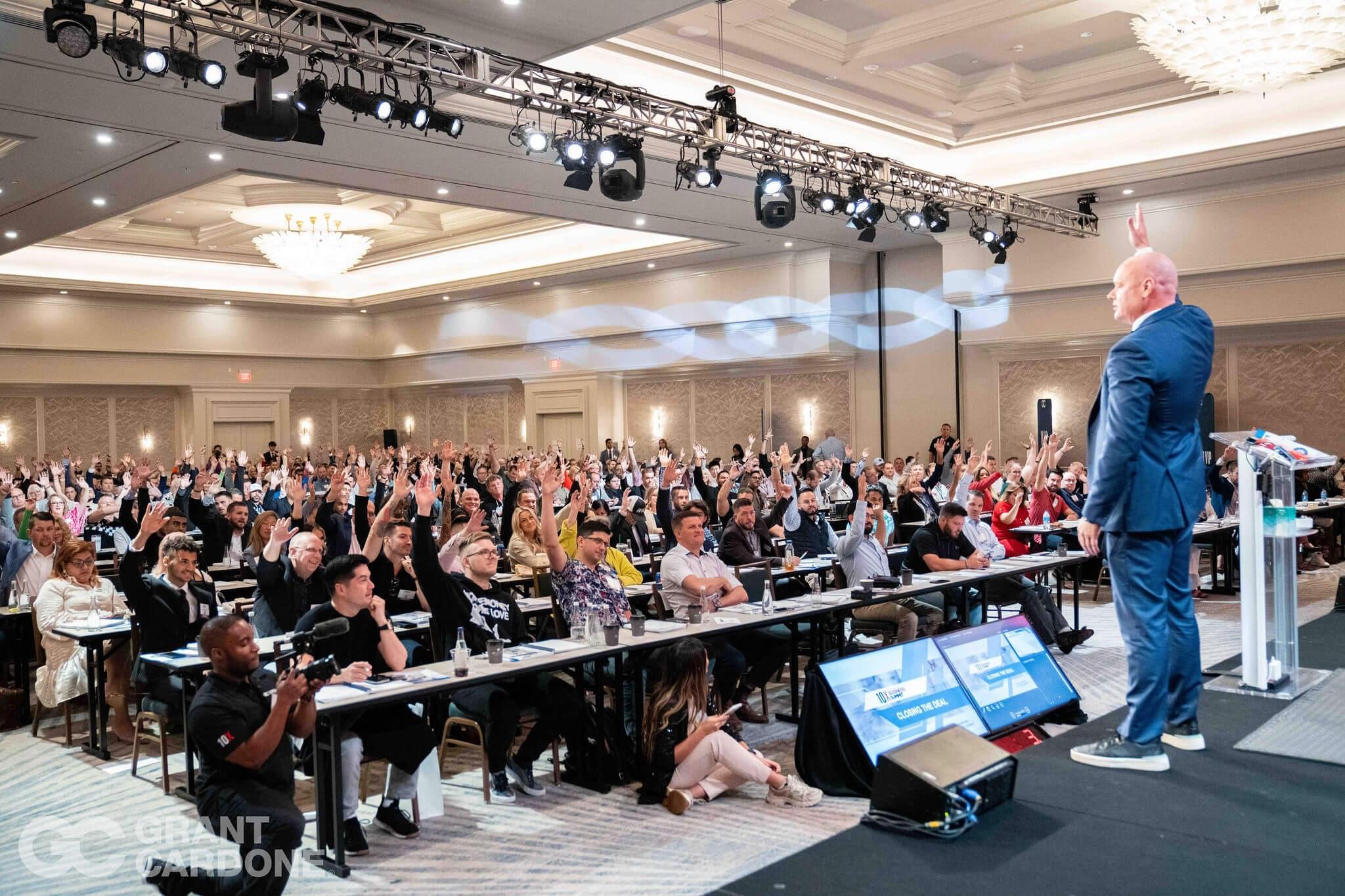 Grant Cardone with an owner on stage