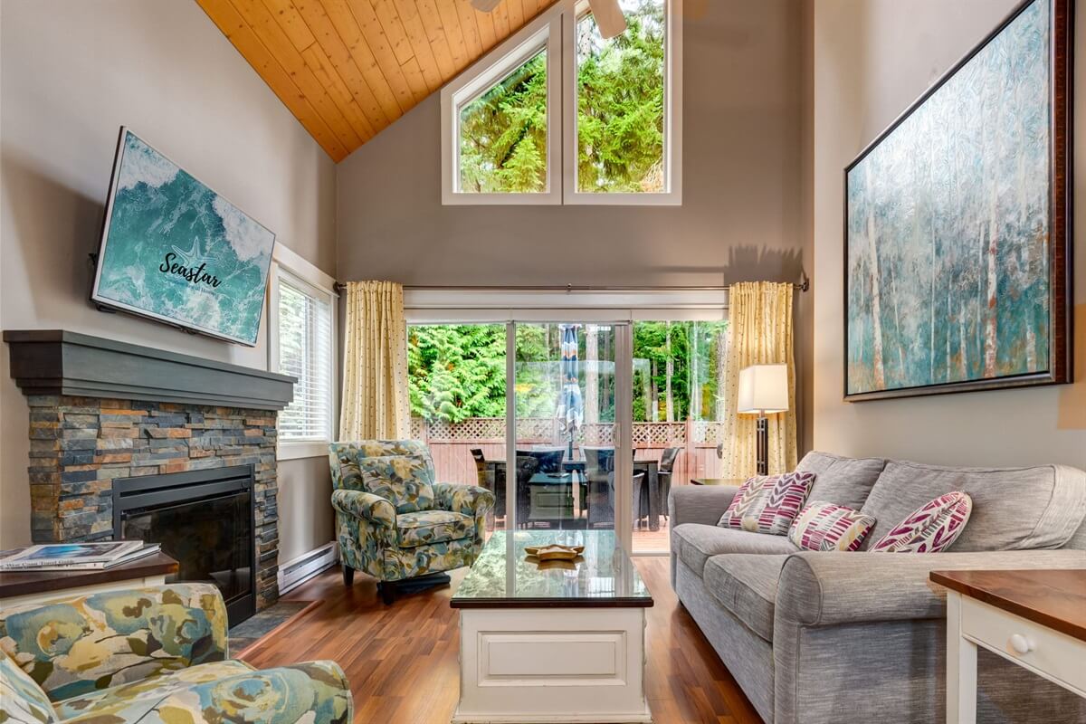 Seastar property — vaulted living room with stone fireplace