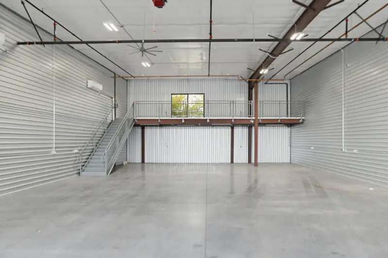 Empty air conditioned garage interior with a steel mezzanine