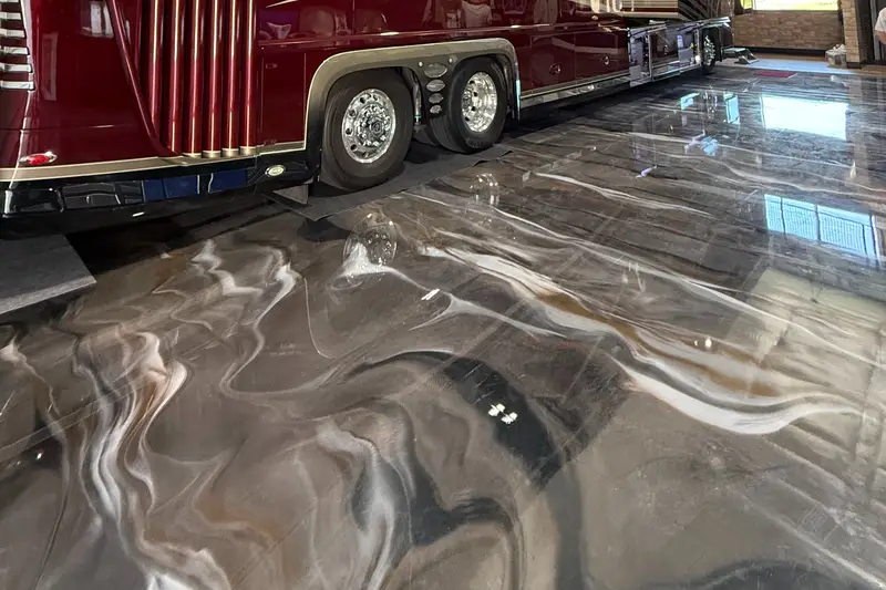 Metallic epoxy floor under a motorcoach