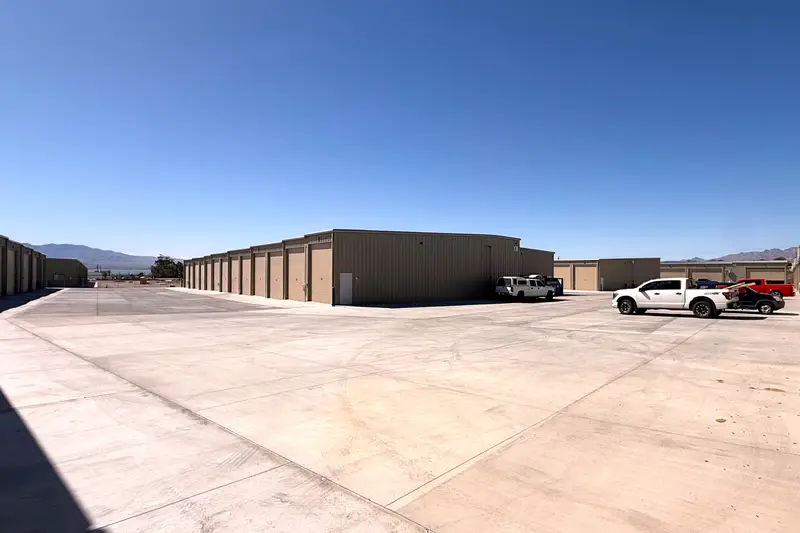 Wide concrete drive aisle between garage buildings
