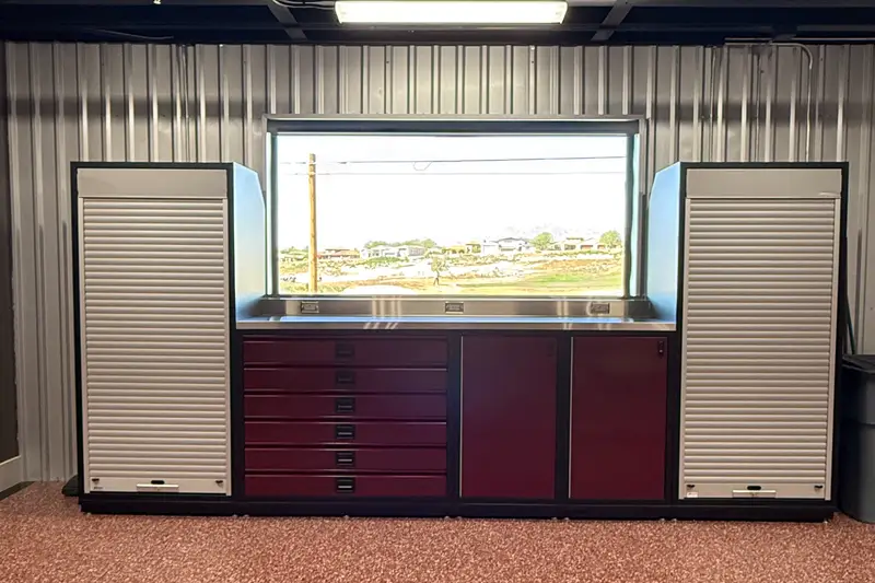 Owner-installed cabinets and workbench under a garage window