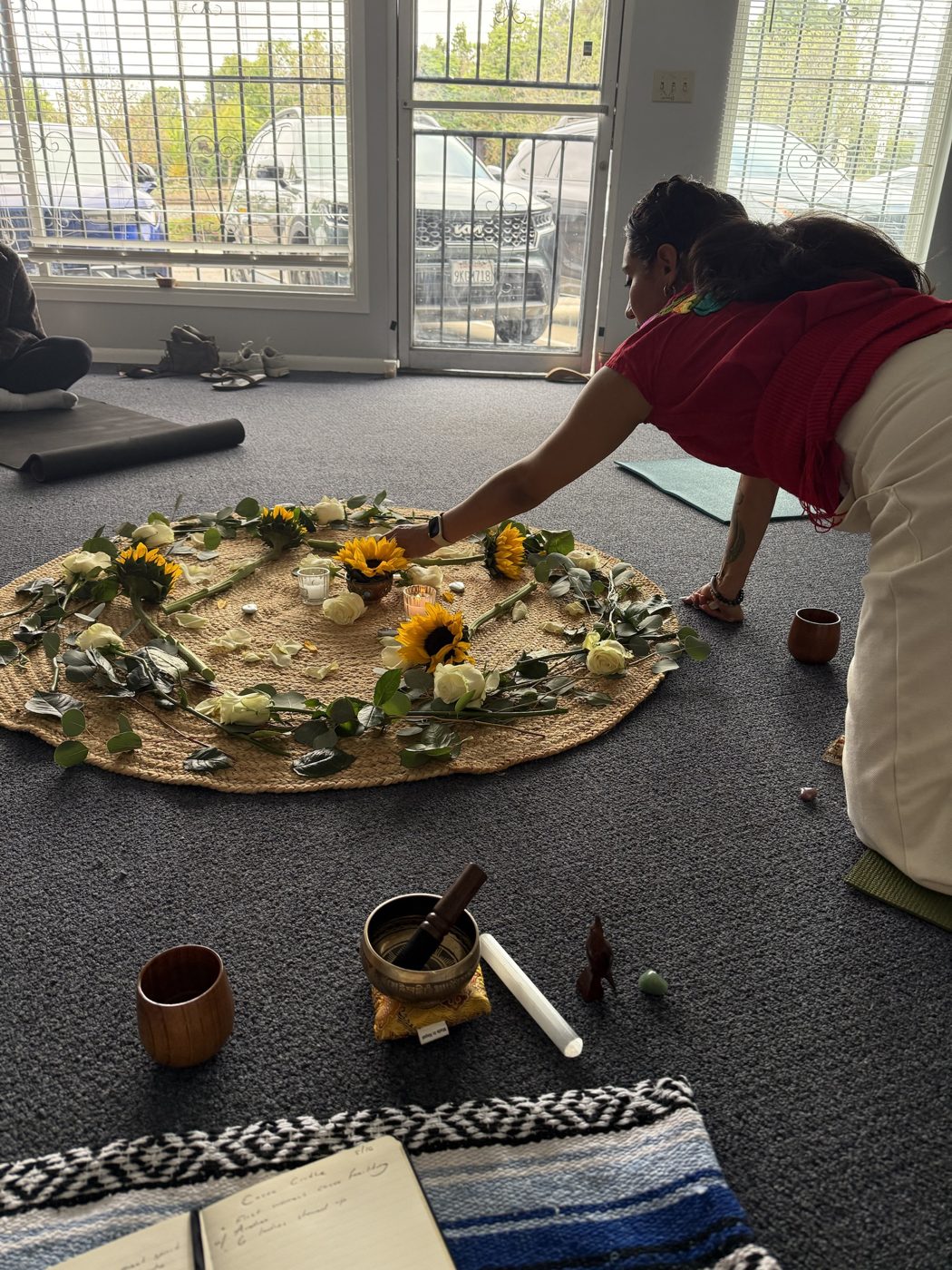 Andrea placing a sunflower on the circle altar