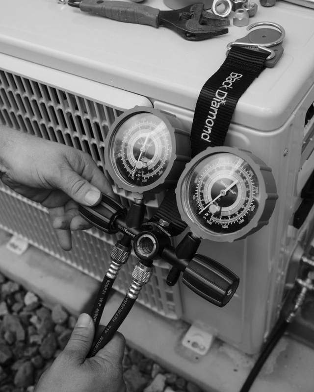 Gauges on a split system outdoor unit during pressure testing