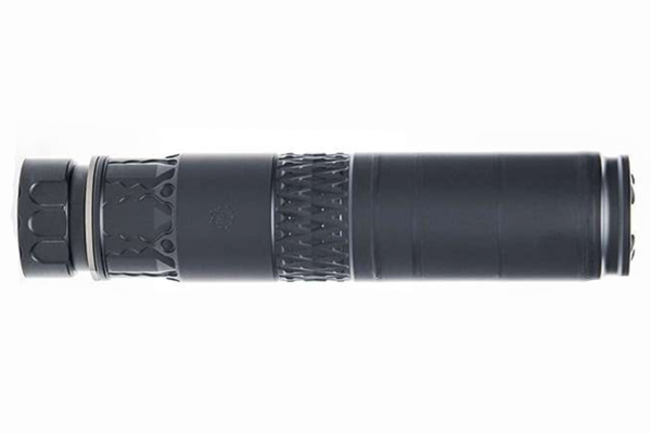 Rimfire pistol equipped with a suppressor on a workbench