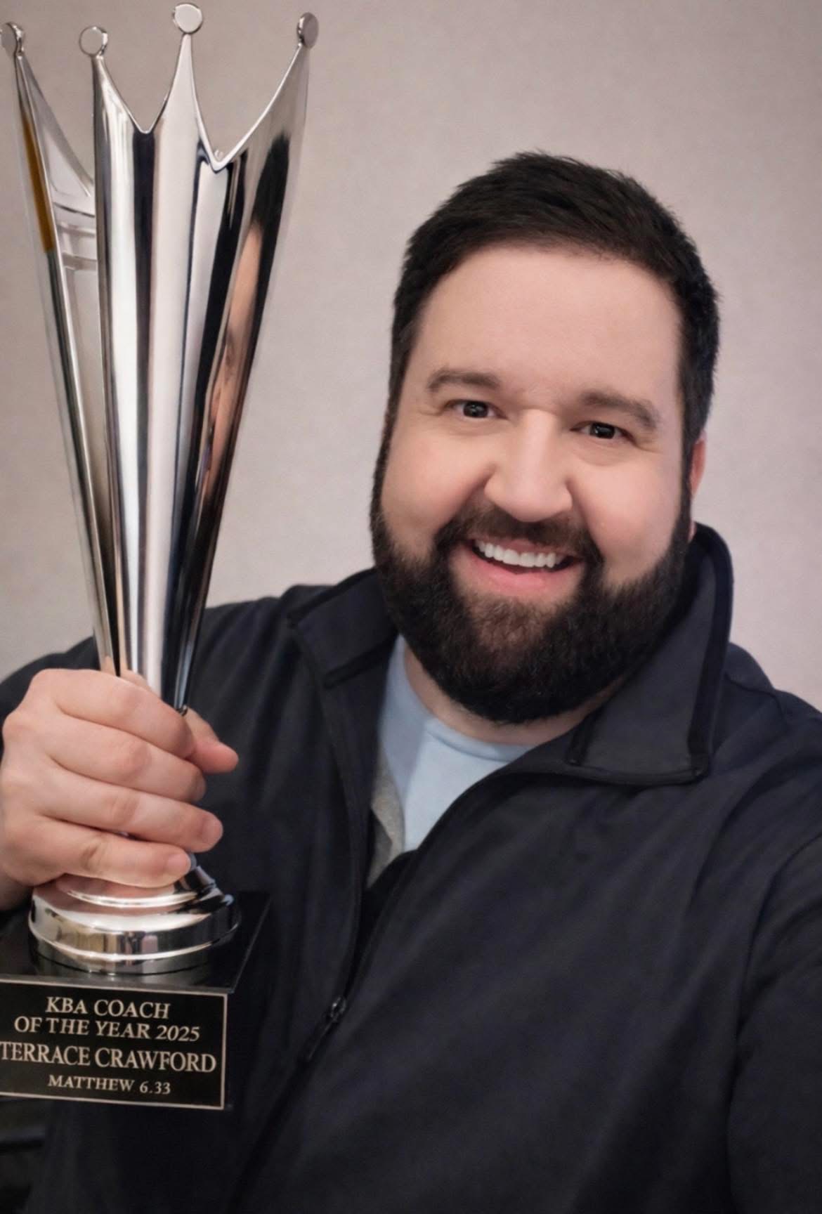 Terrace Crawford holding his 2025 Coach of the Year award