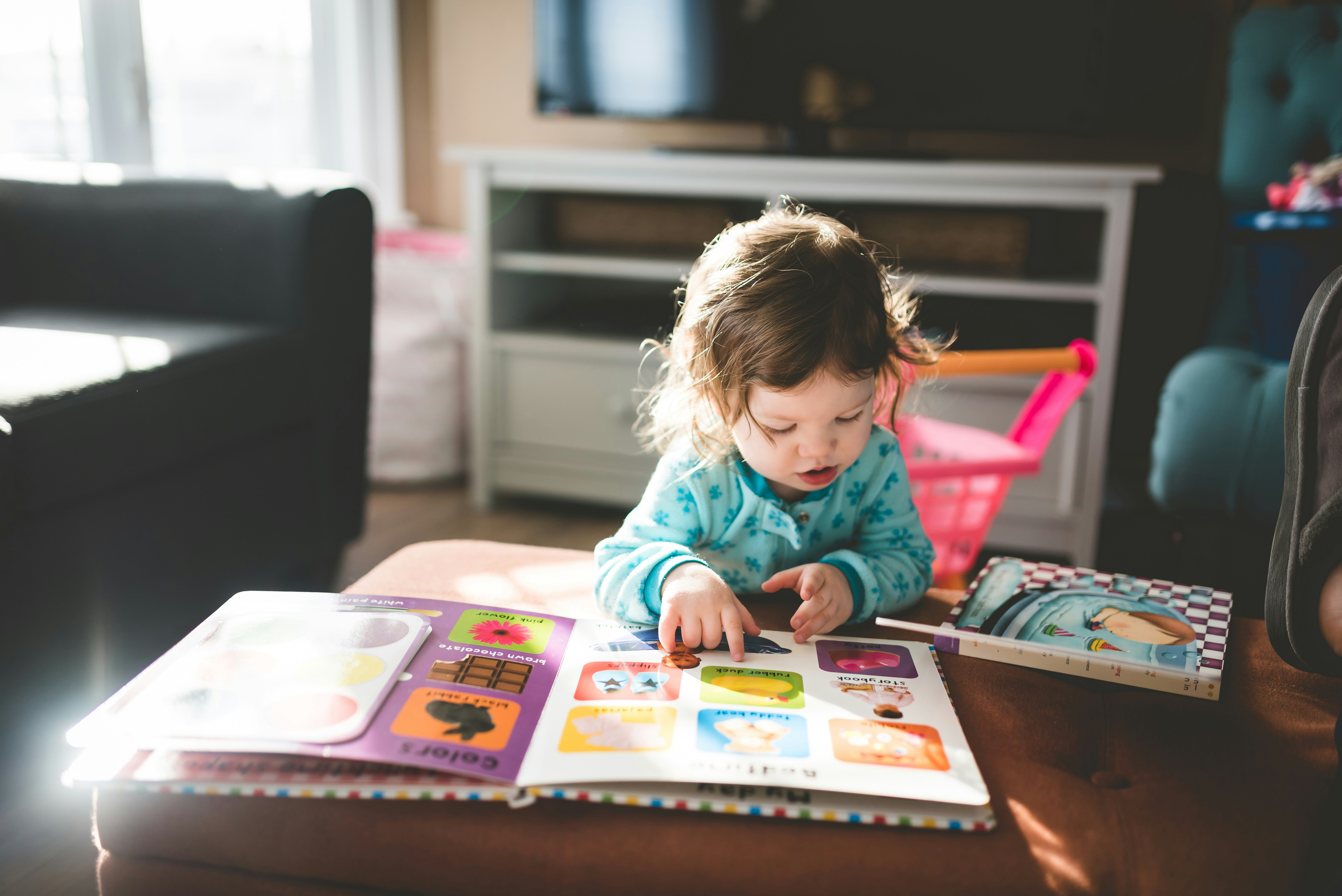 Little girl looking at a book