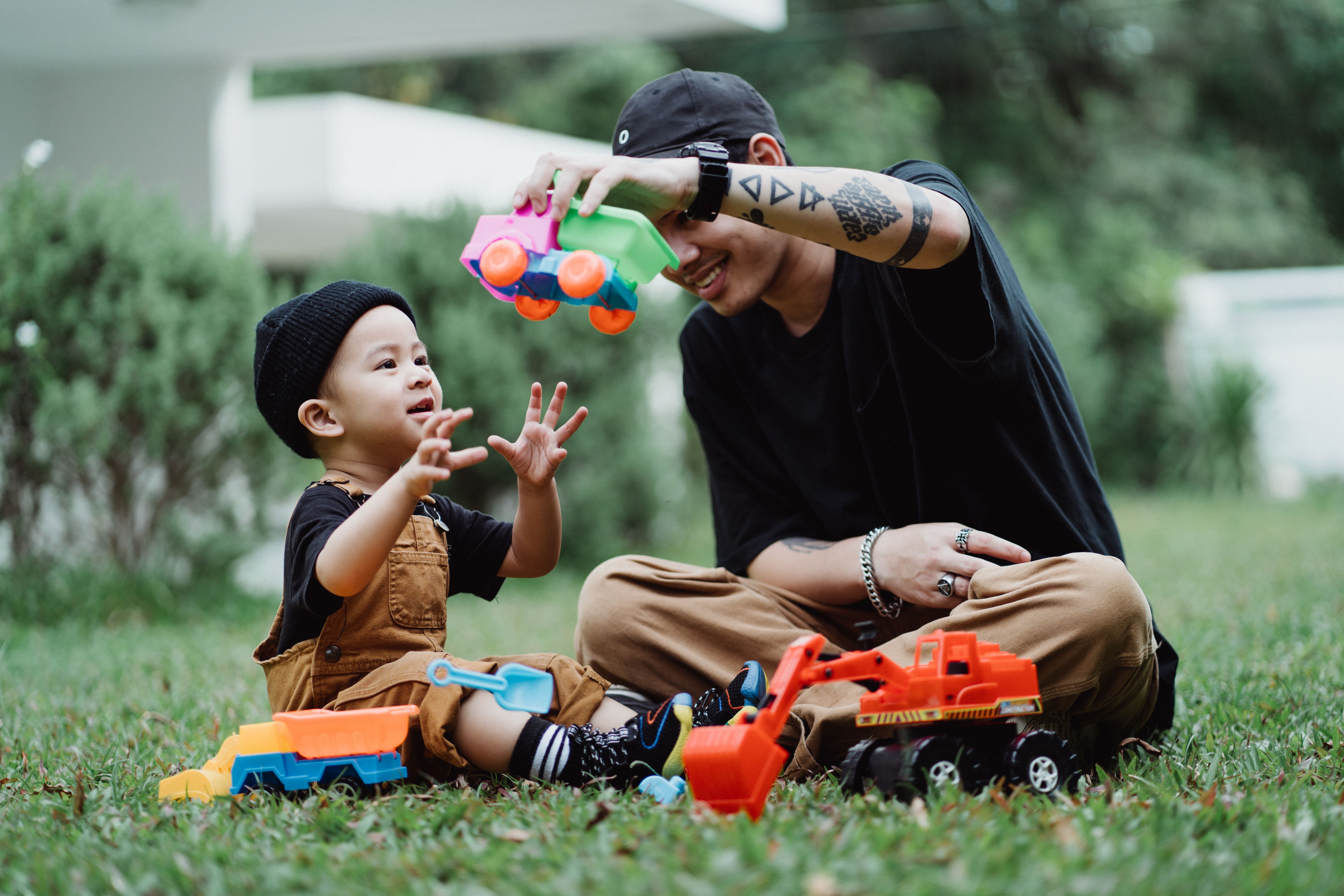 Dad and son playing outside together