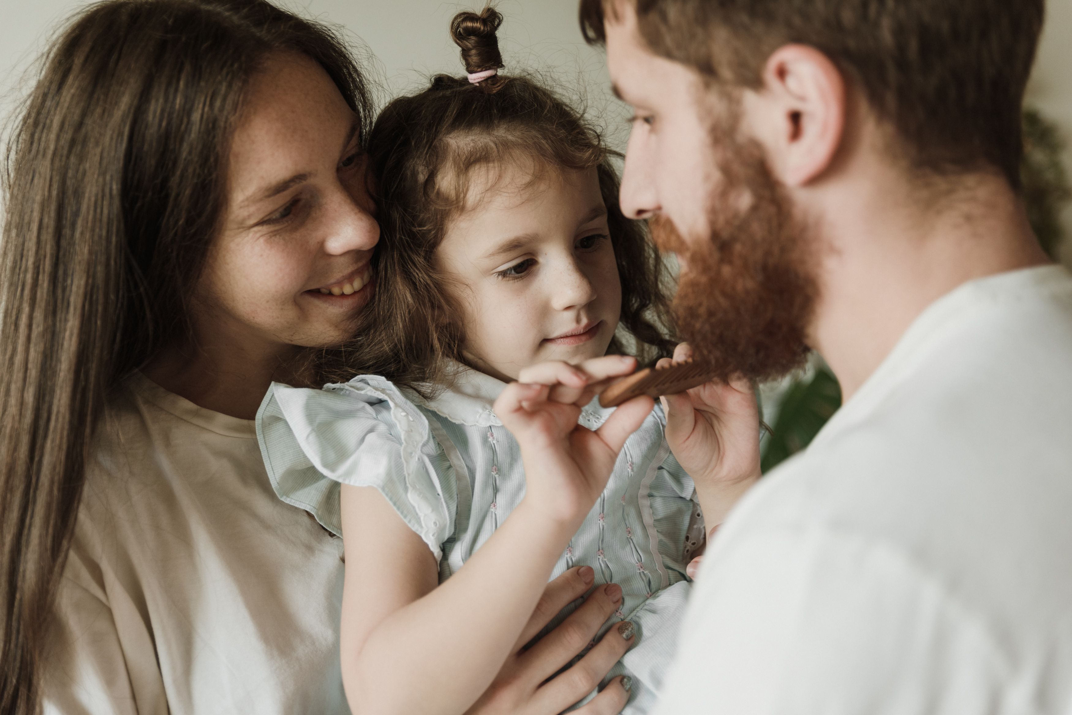 Parents and child close together, sharing a quiet moment
