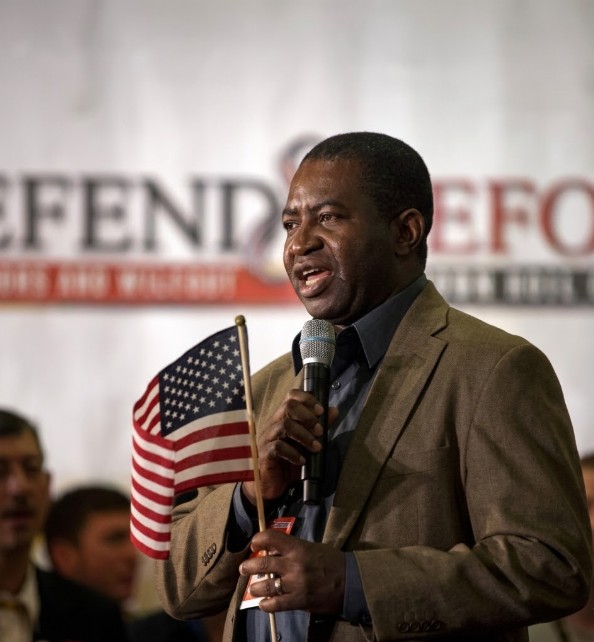 Lee Moultrie speaking into a microphone at a public event