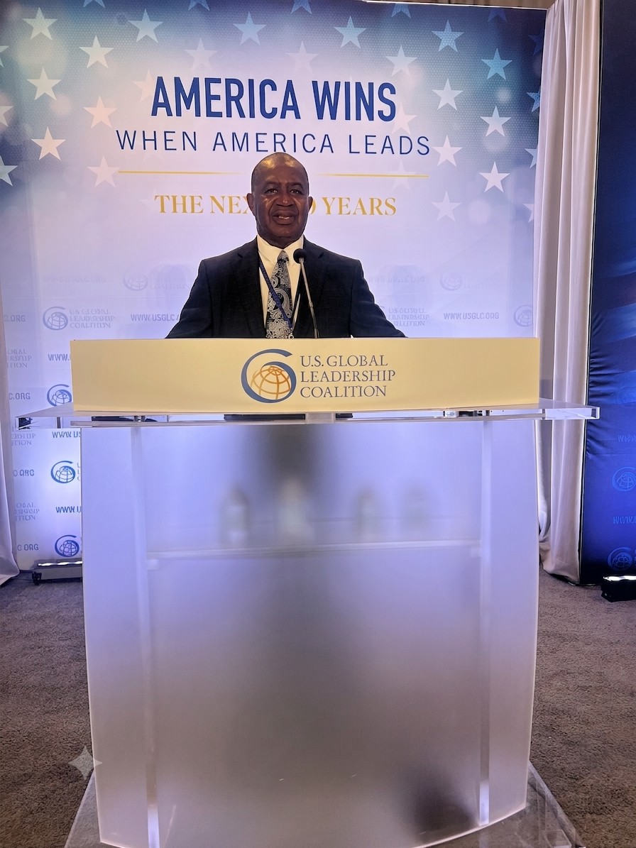 Lee Moultrie speaking from a podium at a leadership event.