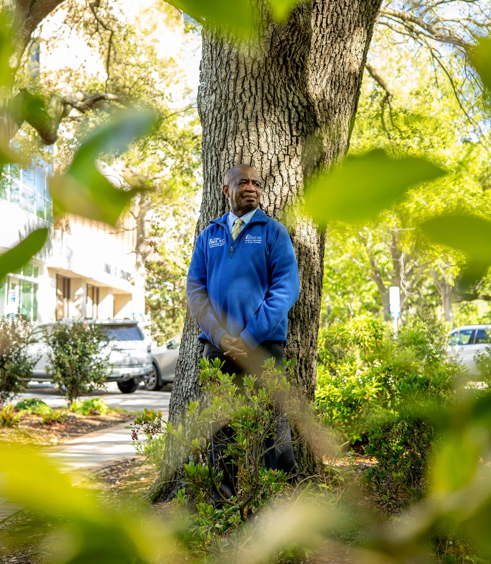 Lee Moultrie standing beside a large tree while wearing an In Our DNA SC and MUSC pullover.