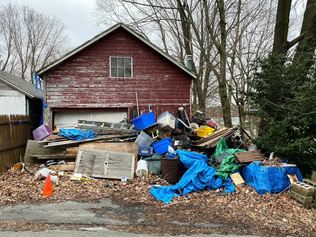 Large pile of outdoor yard debris, wooden shutters, and plastic totes staged for junk removal in Toronto.
