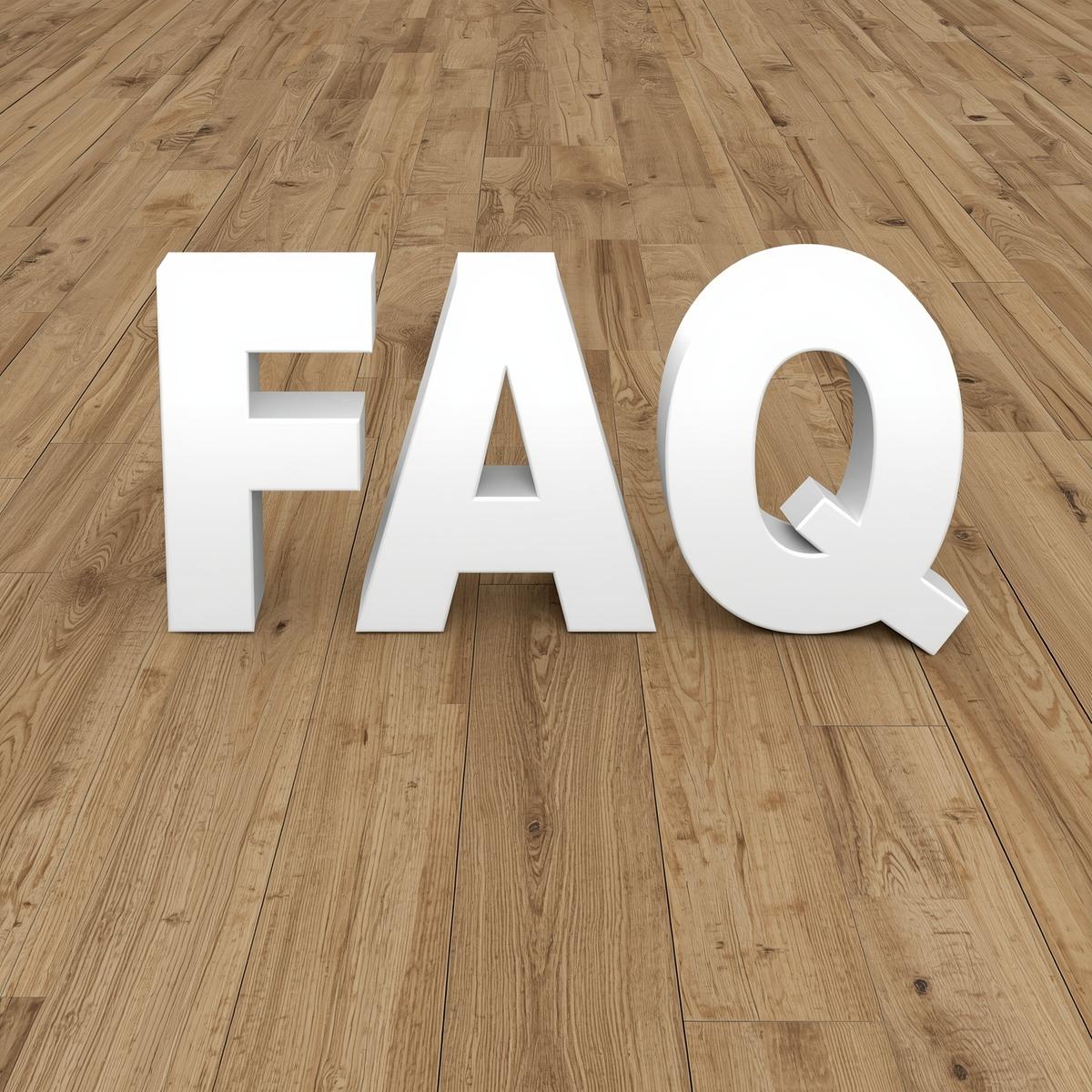 White letters spelling "FAQ" on hardwood floor, emphasizing customer inquiries about AZ Floor Haven's flooring services and products.