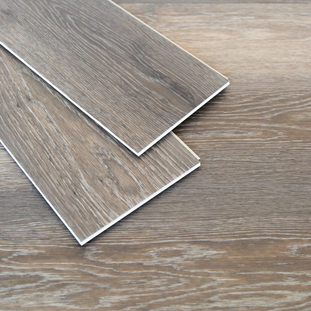 Luxury Vinyl Plank (LVP) flooring samples showcasing realistic wood grain texture and durable layered construction, ideal for high-traffic areas.