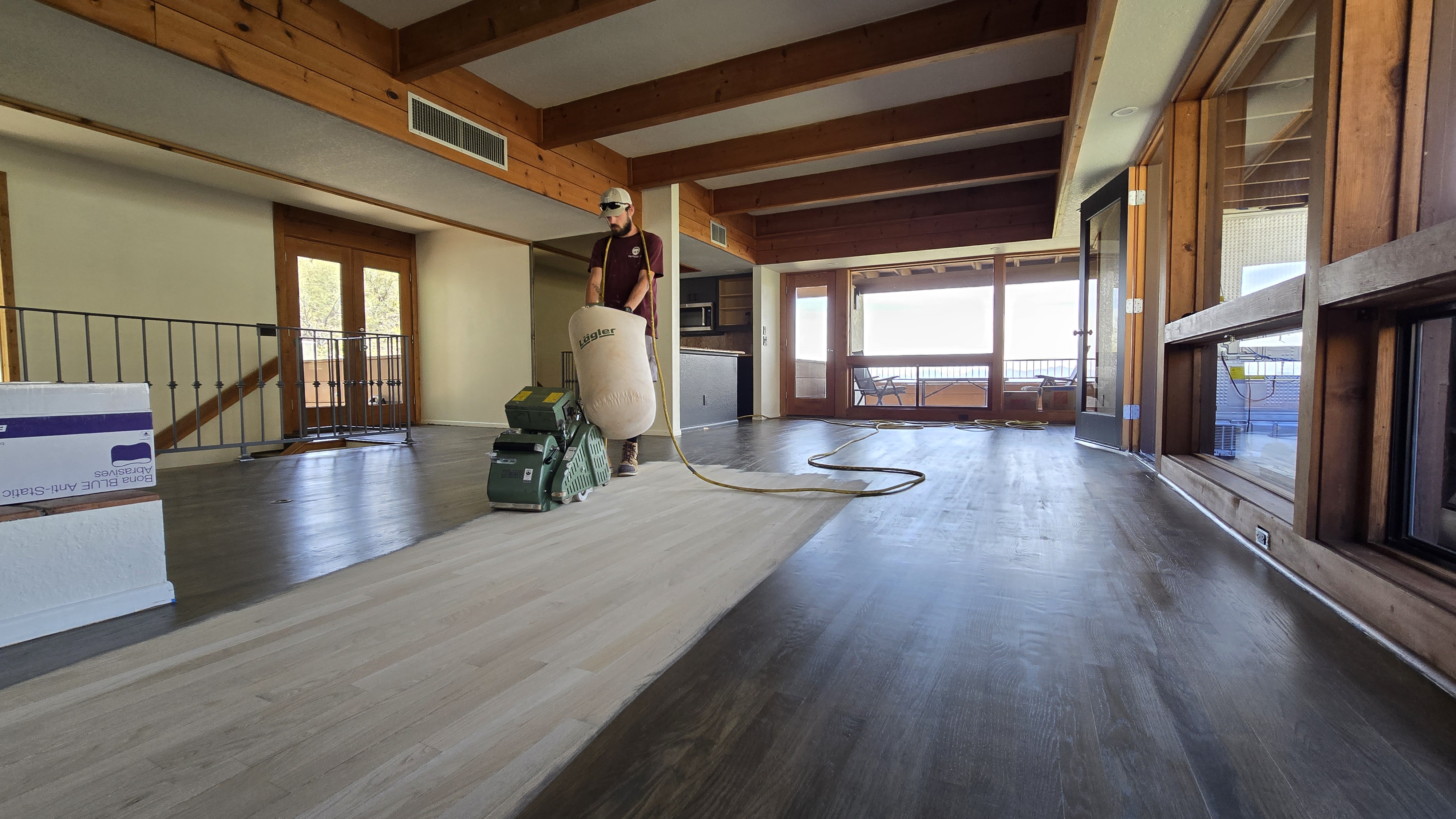 Professional dust-contained sand and finish of hardwood floors in a Tucson home to restore their natural beauty and warmth by AZ Floor Haven