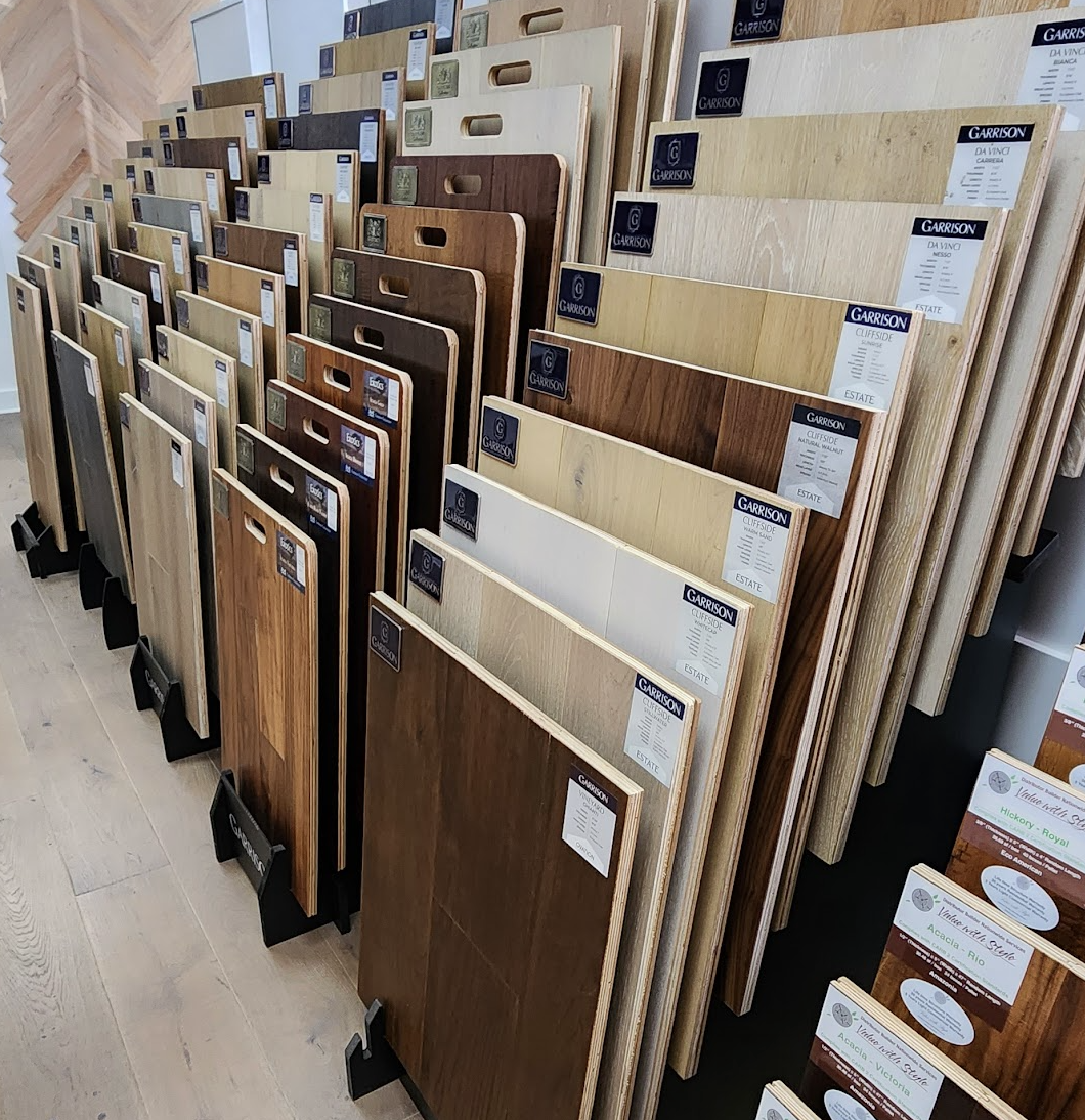 Premium flooring samples displayed in a mobile showroom consultation, allowing homeowners to compare colors and textures under natural lighting in their own homes.
