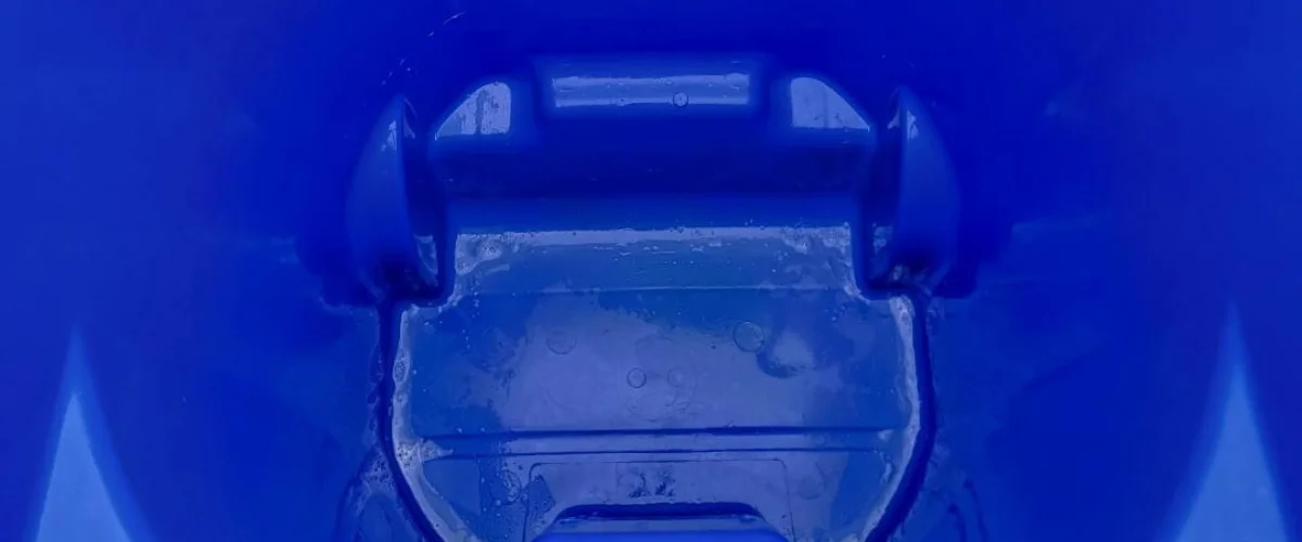 Close-up abstract view of a vibrant blue plastic surface with textured details and water droplets or condensation. Close-up abstract view of a vibrant blue plastic surface with textured details and water droplets or condensation.