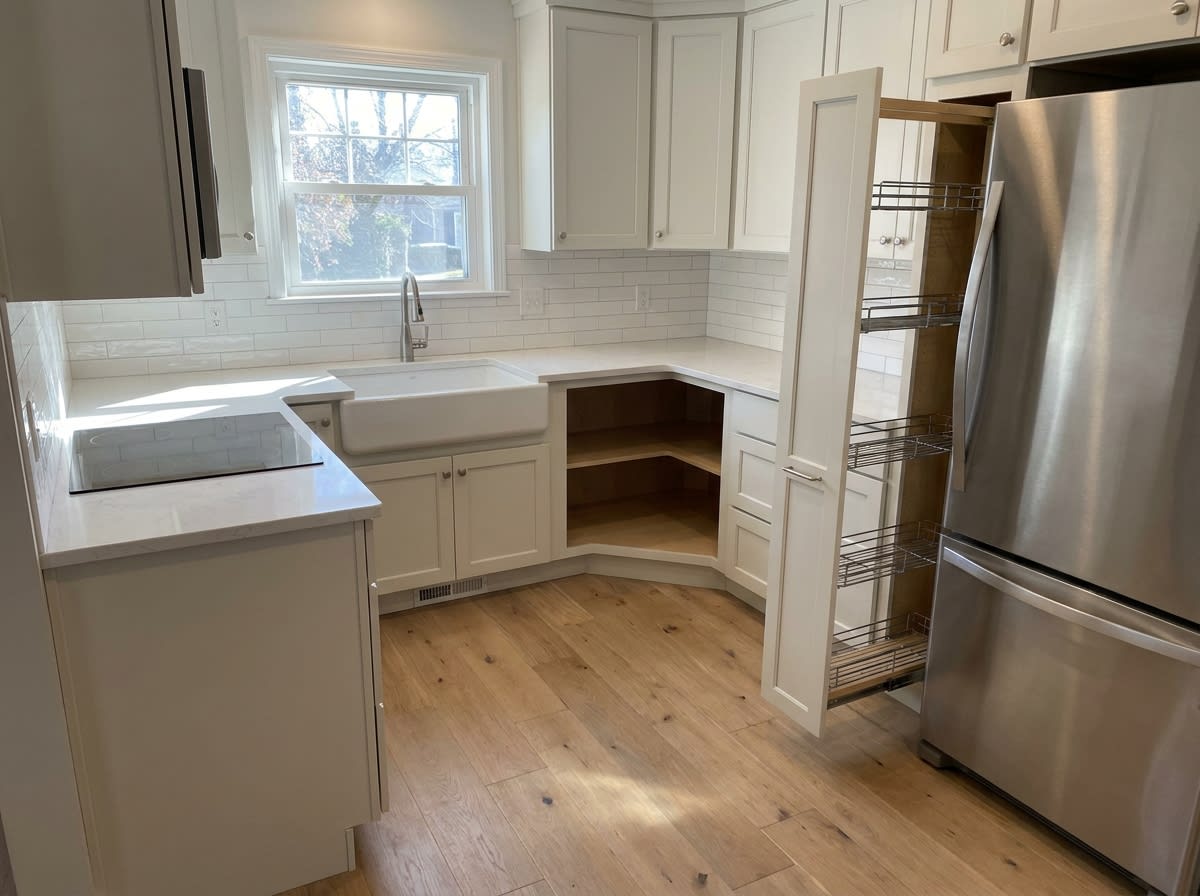 Efficient small kitchen layout with custom corner cabinets and pull-out pantry