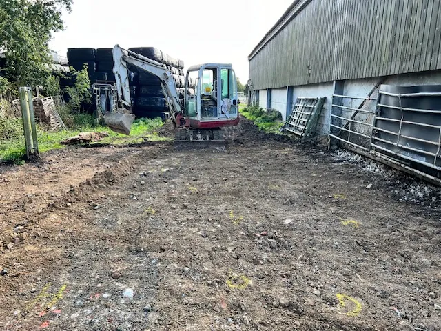 Mini digger preparing ground for a concrete base