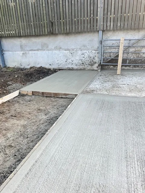 New concrete base meeting an existing slab