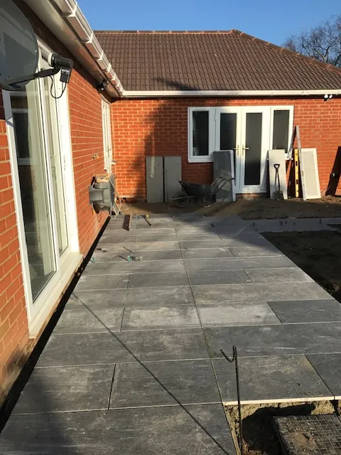Paved patio and path along the back of a bungalow