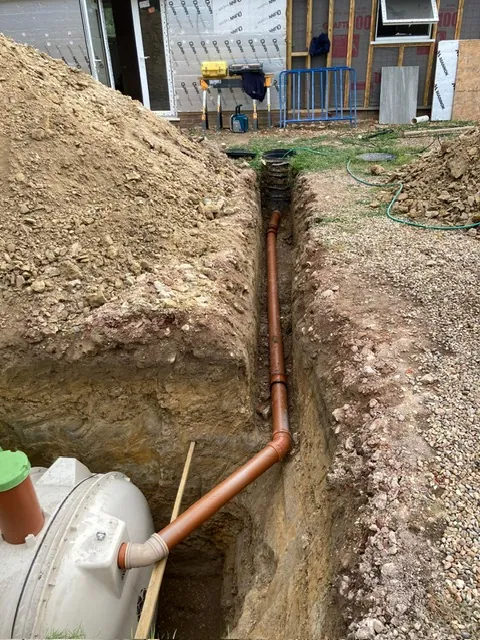 Drainage trench with pipework leading to a tank