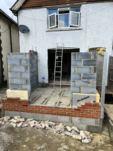 Blockwork walls rising for a rear extension on a brick base