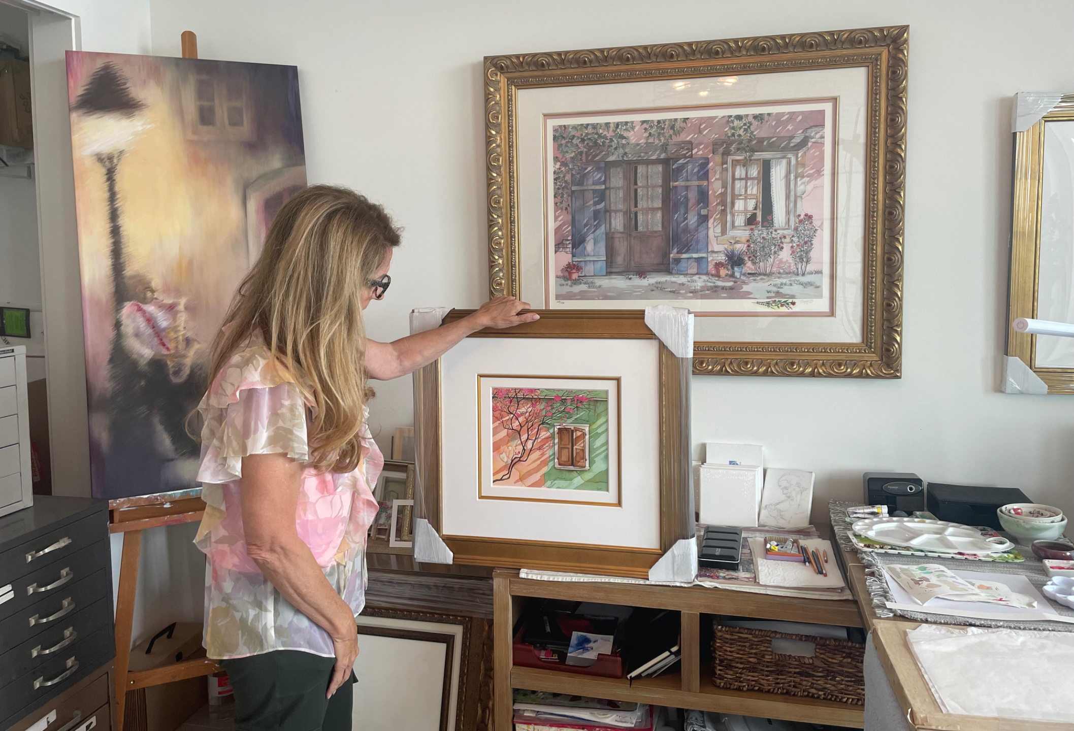 Pomm in her studio with a finished watercolor painting