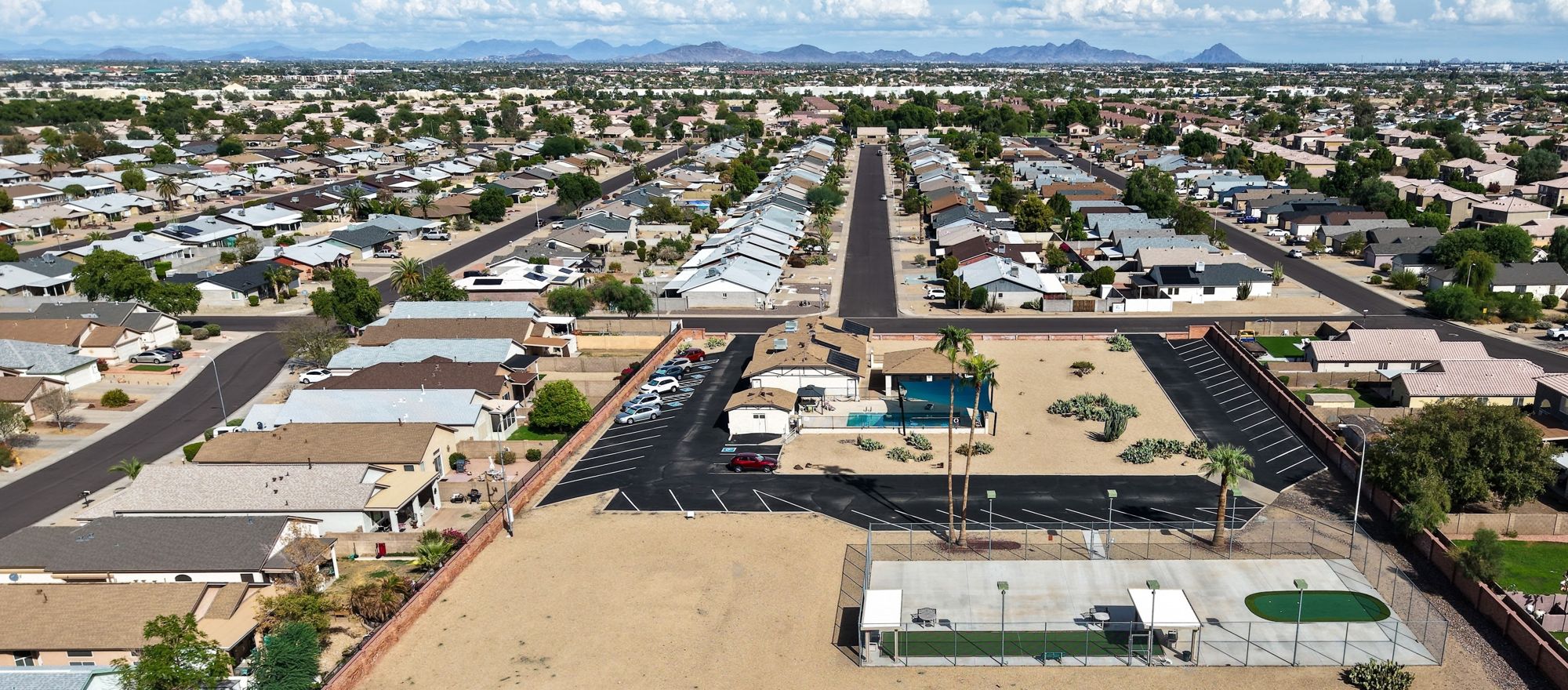 Aerial view of the Sun Air Estates Rec Center, pool, and courts, with the mountains behind.
