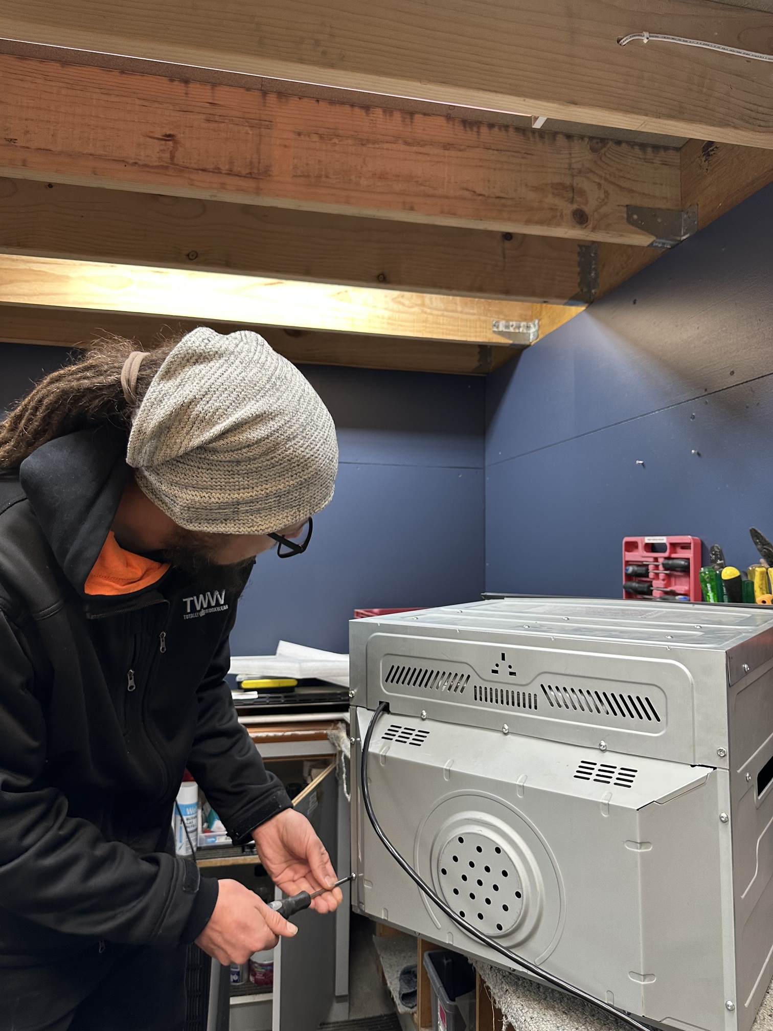 Technician repairing an appliance in the Hopwoods workshop