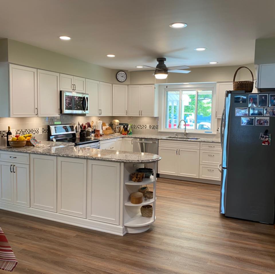 Kitchen Remodeling — White island with curved shelving, granite counters
