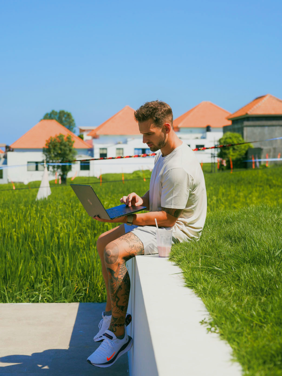 FitPro coach working from a laptop outdoors